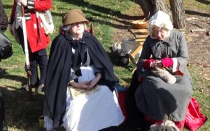 Photo of two re-enactors portraying women of the camp