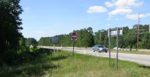Photo of modern highway bridge lined with trees