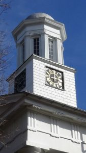 Photo of the clock tower, four sides with clock faces below an octagonal cupola