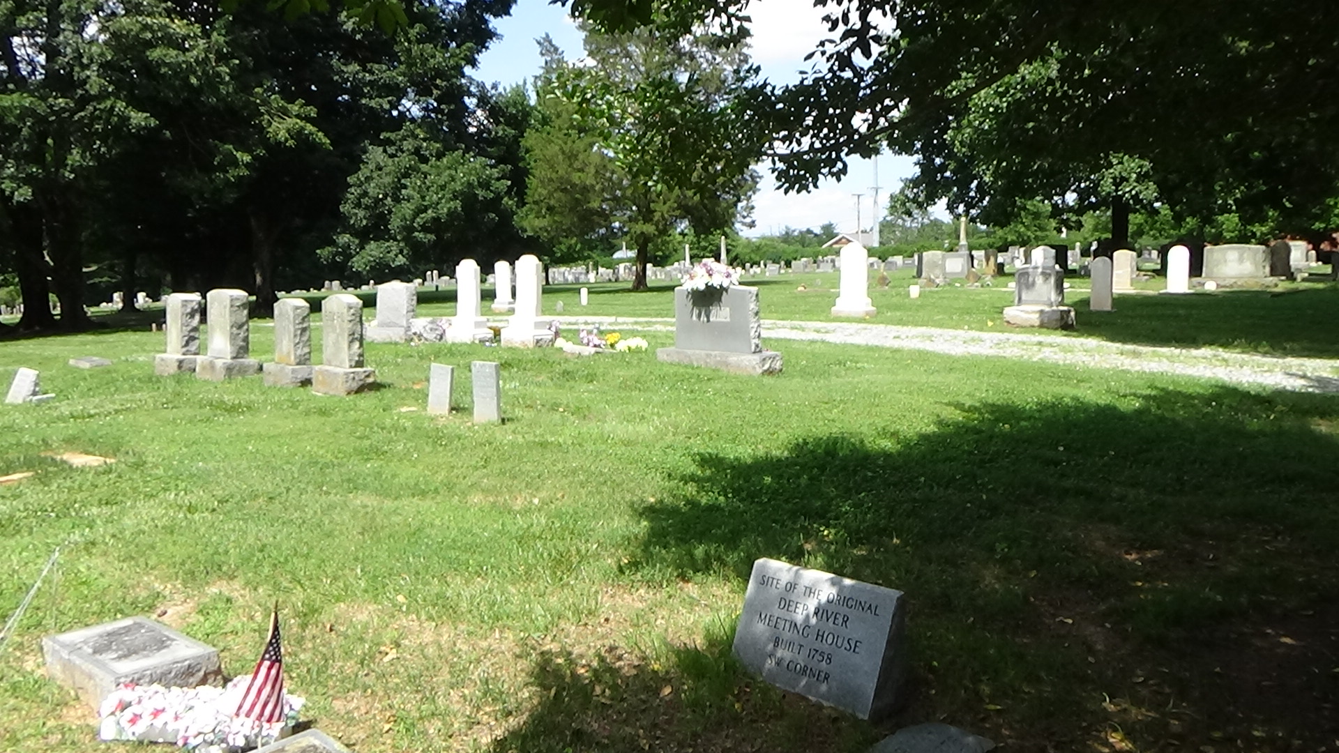 Photo of an empty, grassy area within a cemetery