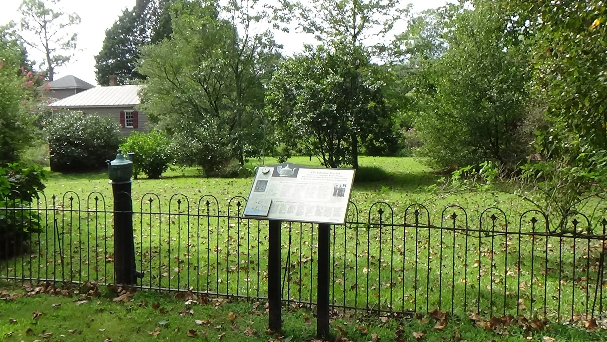 Photo of grassy lot behind a low fence