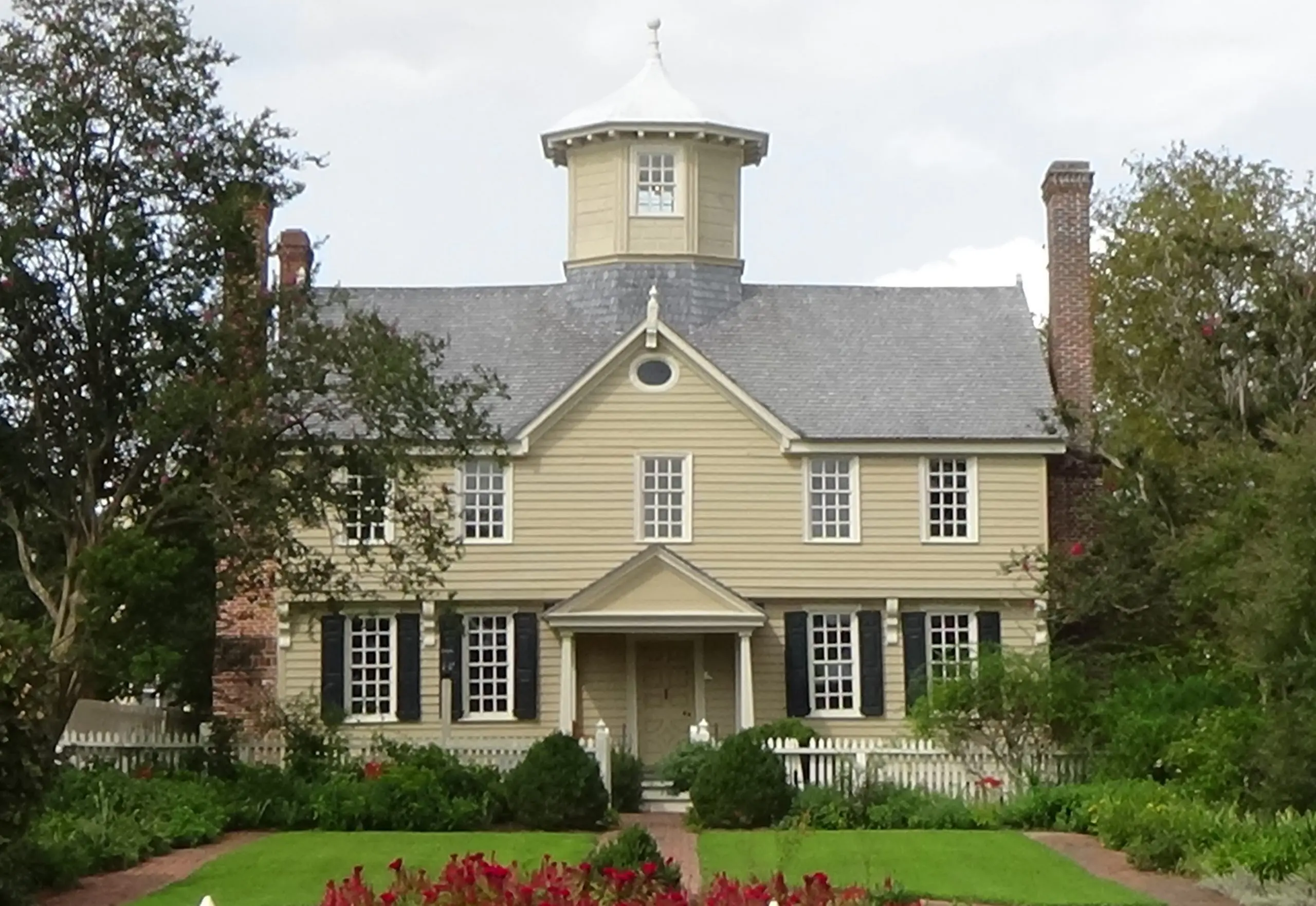 Photo of two-story house with cupola at top center