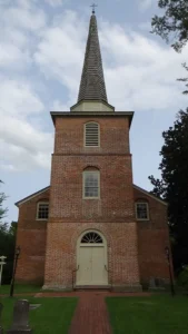 Photo of brick church front with steeple
