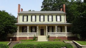Photo of two-story house with porch on lower level