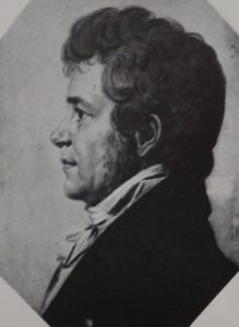 Drawing of a man's face in left profile, with dark curly hair and long sideburns, in a dark coat and white cravat