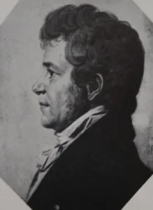 Drawing of a man's face in left profile, with dark curly hair and long sideburns, in a dark coat and white cravat