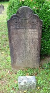 Photo of a tombstone wiith decorative whorls on top