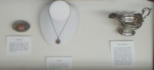 Photo of a snuff box, locket, and silver sauce boat associated with Flora MacDonald