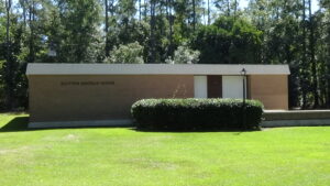 Photo of the center, a small single-story building without windows
