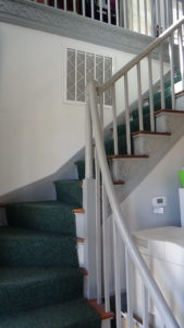 Photo of an open staircase with a turn to the right