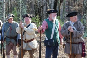 Photo of four men in backwoods clothing with muskets