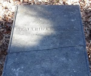 Photo of a flat, grave-length marker with a break line across the middle