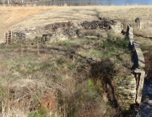 Photo of a stone foundation wall about four feet high